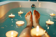 closeup of persons feet in bath, surrounded by floating candles