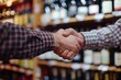 closeup of handshake, wine shop deal, shelves blur