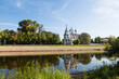 The Church of St. John Chrysostom on the bank of the Vologda River and its reflection in the water in the early morning. Vologda, Russia