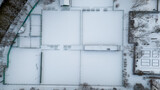 Fototapeta  - Drone photography of tennis courts covered by snow in a city public park during winter day