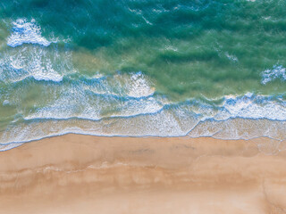  Ocean waves on the beach as a background. Aerial top down view of beach and sea with blue water waves. Vietnam beach