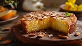 Fototapeta  - A tempting slice of Moroccan almond and orange blossom cake, dense and moist with ground almonds 