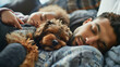 A man and a child sleeping with a dog.