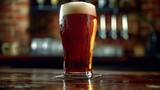 Fototapeta  - A traditional British pint of ale, showcasing the rich amber color and frothy head, served in a classic pint glass with condensation forming on the sides.