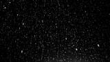 Fototapeta  - Snow falling against a dark background with a street light