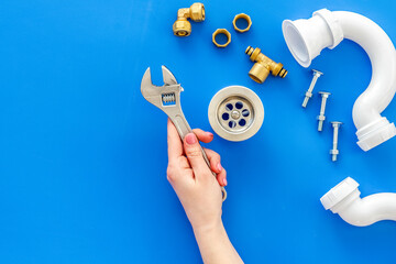 Poster - Plumber profession with gear and instruments for repair tubes on blue background top view copyspace