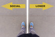 Social or Loner choice, text on asphalt ground, feet and shoes on floor