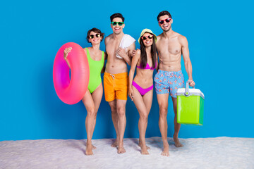 Sticker - Full length photo of excited funny fellows company wear swimsuits going beach picnic isolated blue color background