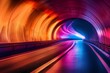 Vivid colors light up a modern tunnel creating a captivating scene with a curved roadway leading into the distance.