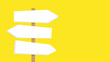 Triple directional signpost on yellow background. Three blank directional arrow signs mounted on a single post, pointing in different directions against a yellow backdrop.