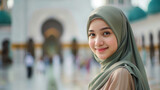 Fototapeta Natura - a happy young lady wearing stylish hijab with a mosque background