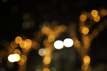 Wall Mural - blurry background image of defocused golden color abstract city street lights at night