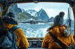Two adventurers in yellow jackets gaze at the icy waters and rugged mountains from the warmth of a vessel's cabin