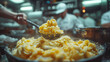 Chefs preparing gourmet macaroni and cheese in a professional kitchen, focus on the dish with blurred background.