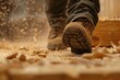 closeup of workers boots walking on scattered sawdust