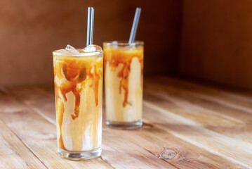 Wall Mural - ice caramel macchiato coffee on  wooden table.