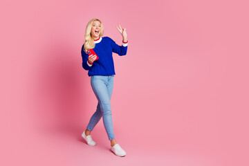 Sticker - Full size photo of pretty lady hold smart phone walk show v-sign wear blue sweater isolated on pink color background