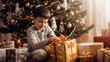 Adorable jews boy unpacking gift sitting on floor by christmas tree at home.