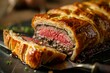 A closeup shot capturing a single Beef Wellington slice on a plate with a knife, showcasing the savory texture and presentation