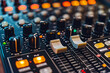 © Fabio - An array of rotary controls, sliders, and buttons on audio mixing console