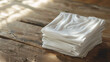 Neatly Folded White T-Shirts on Wooden Surface