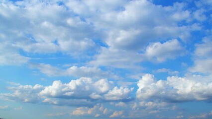 Wall Mural - Beautiful cumulus clouds slowly move across the sky. Calm landscape with white clouds and blue, summer sky.