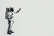 This astronaut stands welcomingly with open arms against a neutral grey background, symbolizing openness to the unknown