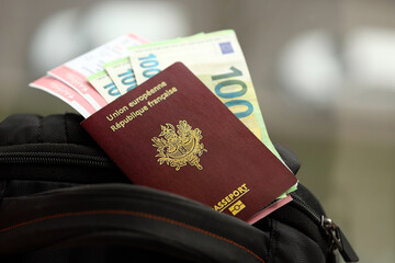 Wall Mural - French passport and euro money bills with airline tickets on backpack close up