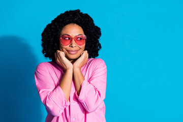 Wall Mural - Photo of pretty young woman look empty space think wear pink shirt isolated on blue color background