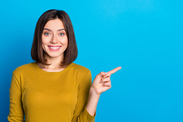 Wall Mural - Photo of pretty adorable lady dressed shirt pointing finger empty space isolated blue color background