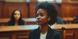 A Black female lawyer zealously advocates for defendants' rights in court before a judge and jury. Concept Lawyer, Advocacy, Defender, Justice, Courtroom