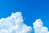 Fototapeta Desenie - Bright Large white cumulus clouds with blue sky background. Big clear cumulus clouds and blue sky texture
