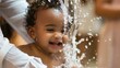 A baby smiling as water is poured over their head during the baptism.