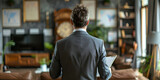 Fototapeta  -  A businessman from the back against a different background of a restaurant, room, landscape.