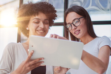 Two women analyzing documents office. Woman executives at work in office discussing some paperwork.