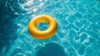 Yellow swimming pool ring float in blue water. concept color summer