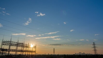 Wall Mural - silhouetted electricity at sunrise time colorful sky background. time lapse of sun rise in the morni