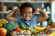 © Sunday Cat Studio - A young boy is standing in front of a table full of fruits and vegetables. He is smiling and flexing his arms muscle, eating healthy food concept