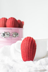 Sticker - Red velvet madeleines on a white plate, red madeleines cake or cookies on a white background