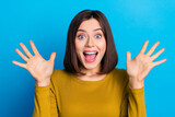 Fototapeta Panele - Photo of excited cheerful woman wear shirt smiling open mouth rising arms palms isolated blue color background