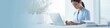© Divine123victory - Nurse or doctor using a laptop for medical records on a white desk with a blurred background, in banner format. Web banner with copy space. Medical Web banner