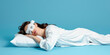 side view of brunette woman in pajamas and night mask sleeping on white pillow isolated on blue, banner