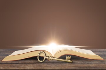 Wall Mural - image of open book with vintage key on wooden table