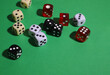 © Наталья Николаева - on a green background there are many dice of different colors and sizes