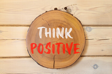 Wall Mural - Think positive symbol. Concept words Think positive on beautiful wooden circle. Beautiful wooden wall background. Business, motivational think positive thinking concept. Copy space.