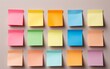 Vibrant sticky notes in various sizes and colors, pinned to a wall forming a creative and inspiring collage