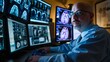 A man, a radiologist, sits in front of multiple computer monitors in a dimly lit room, closely examining digital patient scans
