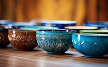 A Variety Of Bowls Elegantly Arranged On A Rustic Wooden Table, Creating A Beautiful And Artistic Display