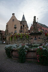 Wall Mural - closeup on downtown Eguisheim in eastern France, Alsace with their typical half timbered colorful buildings and church