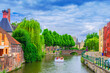 Ghent cityscape, brick buildings and trees plants on bank of Lieve water canal, embankment and Sint-Antoniusbrug bridge in Ghent city centre Prinsenhof Princes Court district, Gent old town, Belgium